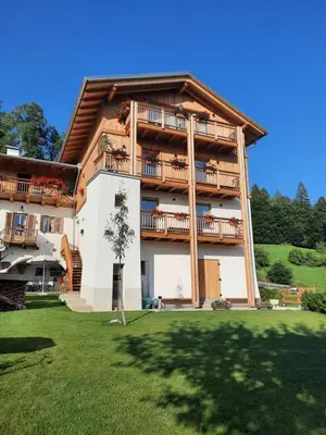 a large building with balconies on the side of it at Maso Alpino con vista sulle Dolomiti in Mendola