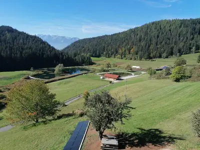 a view of a valley with a river and a road at Maso Alpino con vista sulle Dolomiti in Mendola
