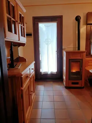 a kitchen with a door with a window and a stove at La tua piccola casa a Pecol in Mareson