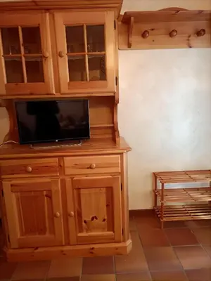 a wooden cabinet with a tv on top of it at La tua piccola casa a Pecol in Mareson
