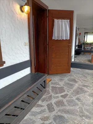 a door to a room with a bench in front of it at La tua piccola casa a Pecol in Mareson