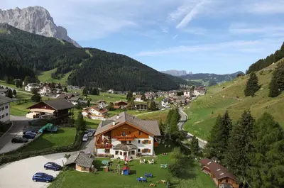 a small village in a valley with mountains at Hotel Val in Selva di Val Gardena