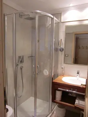 a bathroom with a shower and a sink at Hotel Val in Selva di Val Gardena