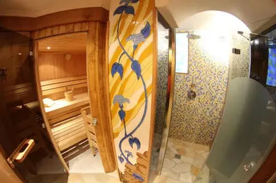 a bathroom with a shower and a toilet at Hotel Val in Selva di Val Gardena