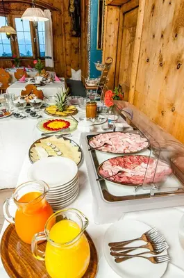 a table with many plates of food on it at Garni Tschutscherhof in Laion