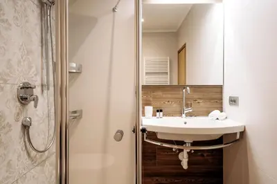 a bathroom with a sink and a shower at Garni Tschutscherhof in Laion