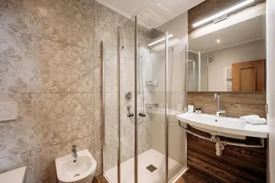 a bathroom with a sink and a shower and a toilet at Garni Tschutscherhof in Laion