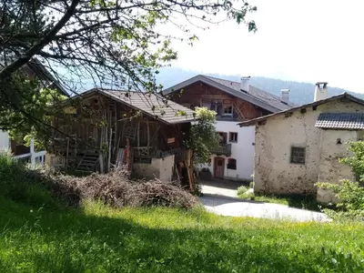 a house in a field next to a building at Schornhof in Aldino