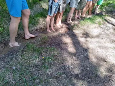 a group of people standing on a dirt road at Schornhof in Aldino