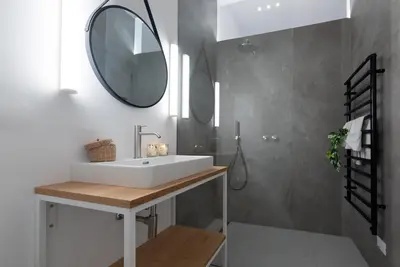 a bathroom with a white sink and a mirror at KERAMIK Suites in Merano