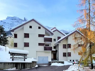 a large white building with snow on the ground at Apartment Enrosadira-9 by Interhome in Alba di Canazei