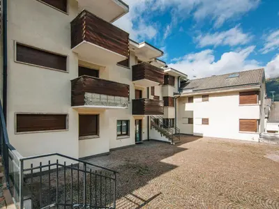 an exterior view of a building with wooden balconies at Apartment Enrosadira-9 by Interhome in Alba di Canazei