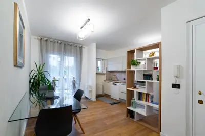 a kitchen and dining room with a glass table and chairs at Terrace 27 in Bolzano