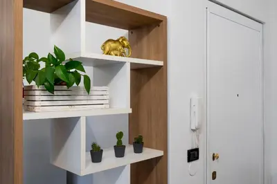 a room with white shelves with potted plants at Terrace 27 in Bolzano