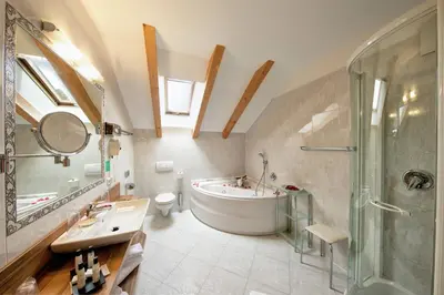 a bathroom with a tub and a sink and a shower at Seehotel Sparer in Appiano sulla Strada del Vino