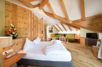 a bedroom with a large white bed in a room at Seehotel Sparer in Appiano sulla Strada del Vino