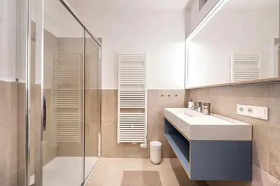 a bathroom with a sink and a shower at Apartments Vedl Luech da Plajes in Ortisei