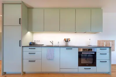 a kitchen with white cabinets and an oven at Apartments Vedl Luech da Plajes in Ortisei