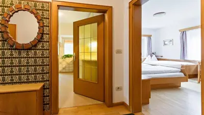 a room with a door leading to a bedroom at Apartments Villa Alpina in Santa Cristina in Val Gardena