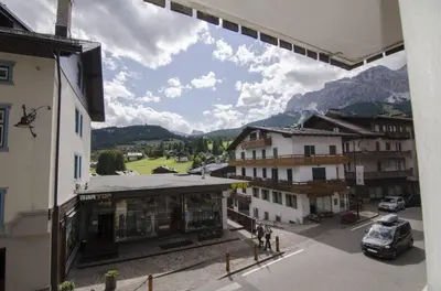 a view of a town with mountains in the background at Accogliente appartamento in Corso Italia in Cortina dʼAmpezzo