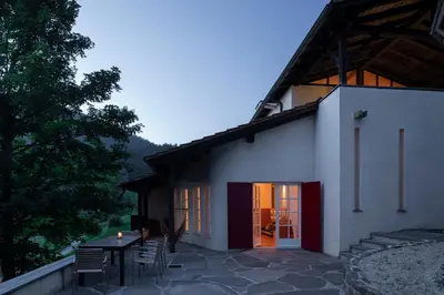 a house with a table and chairs in front of it at Landhaus Leonhard in Egna