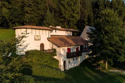 a large white house with a brown roof at Landhaus Leonhard in Egna