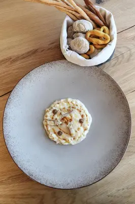a table with a plate of bagels and pretzels at Passo Sella Dolomiti Mountain Resort in Selva di Val Gardena