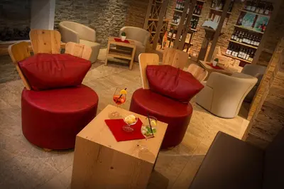 a room with two chairs and a table in a store at Passo Sella Dolomiti Mountain Resort in Selva di Val Gardena
