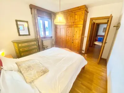 a bedroom with a bed with a pillow on it at FALORIA APARTMENT-splendid view in Cortina dʼAmpezzo