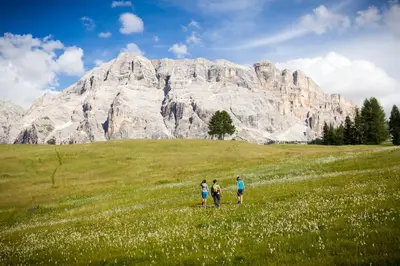 a balcony with a view of a church at Villa Tony - Small Romantic Hotel in Corvara in Badia