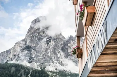 two women standing on a dirt road in the mountains at Villa Tony - Small Romantic Hotel in Corvara in Badia