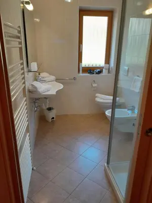 a bathroom with a toilet and a sink and a shower at Landgasthof Sonnegghof in Castelvecchio