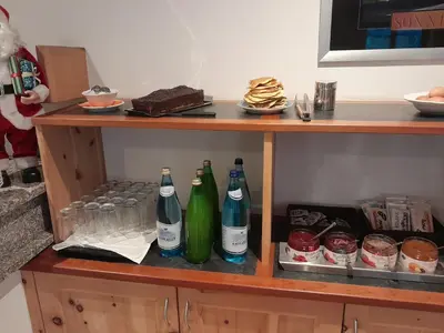 a shelf with bottles and glasses on it at Landgasthof Sonnegghof in Castelvecchio
