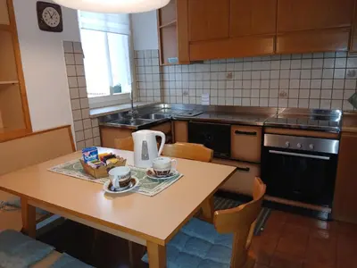 a kitchen with a table with two cups on it at Casa Micéi in Tesero