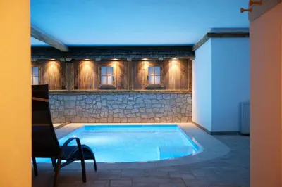 a swimming pool in the middle of a room at Exclusive Chalet Grumer 700 sqm in Soprabolzano