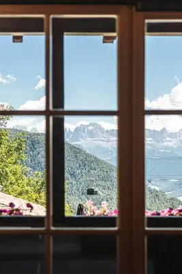a view of mountains through a window at Exclusive Chalet Grumer 700 sqm in Soprabolzano
