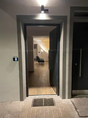 a hallway with a door leading to a room with a chair at Appart-Chalet Litegosa in Panchia