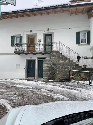 a white building with stairs and a balcony at Appart-Chalet Litegosa in Panchia