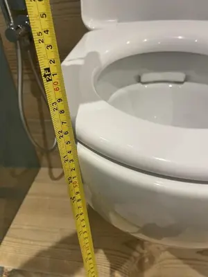 a yellow ruler next to a white toilet at Appart-Chalet Litegosa in Panchia