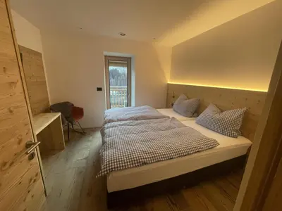 a bedroom with a large bed with two pillows at Appart-Chalet Litegosa in Panchia