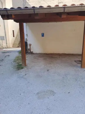 an empty parking lot with a wooden patio at Casa Romy in Rovere della Luna