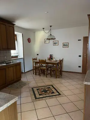 a kitchen and dining room with a table and chairs at Casa Romy in Rovere della Luna