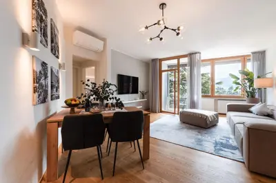 a living room with a table and chairs and a couch at Promenaden Lounge in Merano