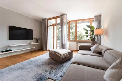 a living room with a couch and a flat screen tv at Promenaden Lounge in Merano