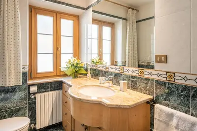 a bathroom with a sink and a mirror at OLIMPIA LODGE in Cortina dʼAmpezzo