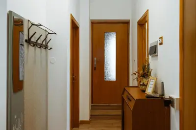 a hallway with two doors and a wooden door at Donatella&Thomas in Siror