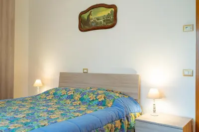 a bedroom with a bed with a colorful bedspread at Donatella&Thomas in Siror