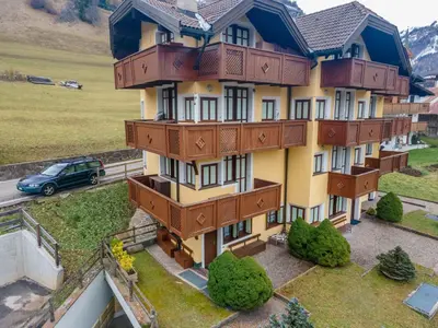 a building with balconies on the side of it at Appartamento Green House in Moena