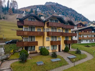 a large apartment building in the middle of a mountain at Appartamento Green House in Moena