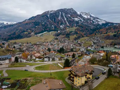 an aerial view of a small town in the mountains at Appartamento Green House in Moena